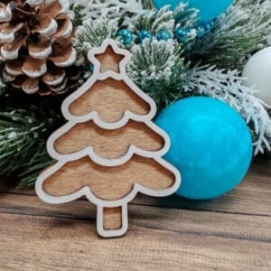 Free 3D layered laser cut wooden Christmas tree ornament in a wavy gingerbread style, displayed as a finished craft project on a rustic background for freecutcrafts.