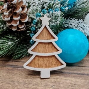 Finished 3D layered wooden gingerbread Christmas tree ornament with a star on top, painted white with a dark stained backing layer.